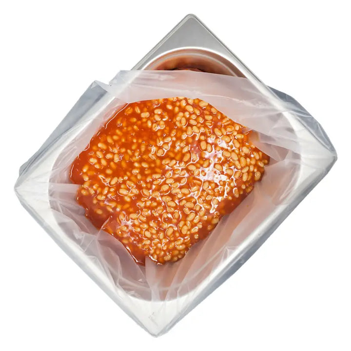 Sesame seed-covered bun in clear packaging for Gastronorm tray pot liner use