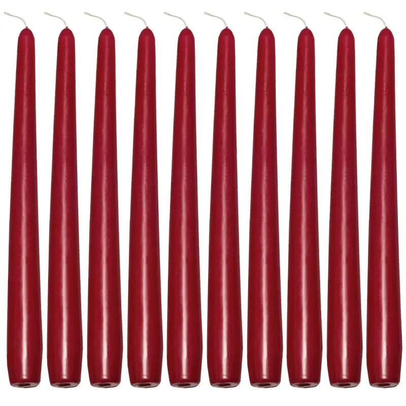 Row of tall, slender red taper candles for elegant dinner settings