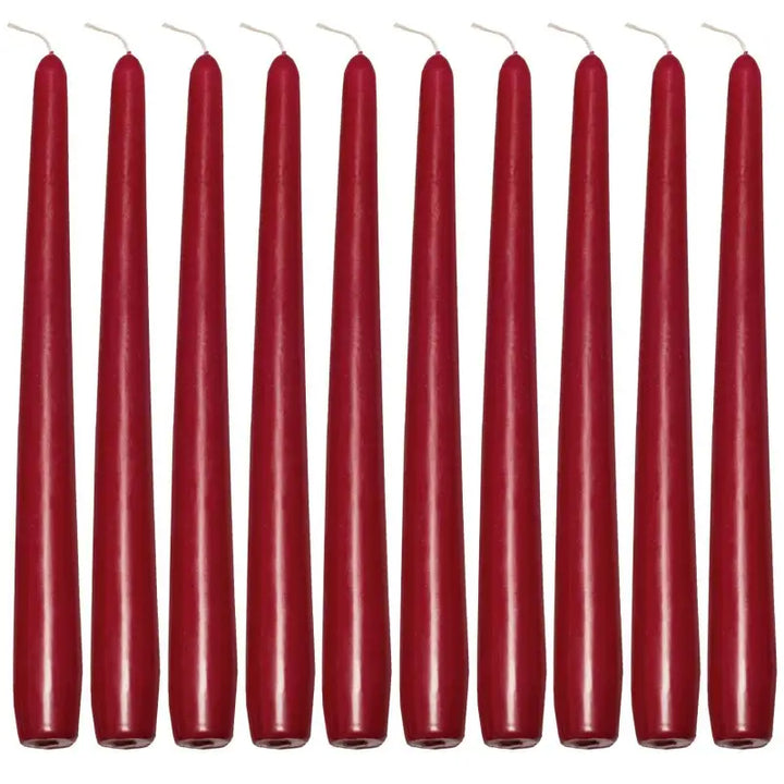 Row of tall, slender red taper candles for elegant dinner settings