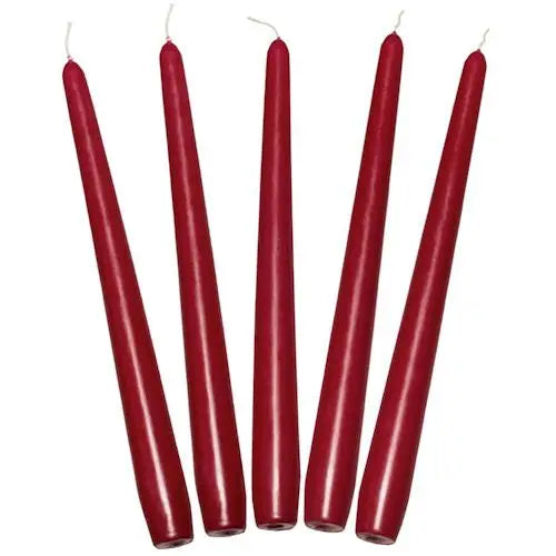 Five tall, slender red taper dinner candles neatly arranged in a row