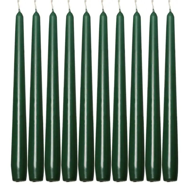 Ten dark green taper dinner candles arranged in a row for elegant dining