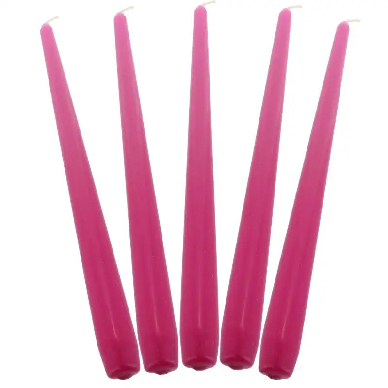 Five pink taper dinner candles arranged in a row for elegant table settings