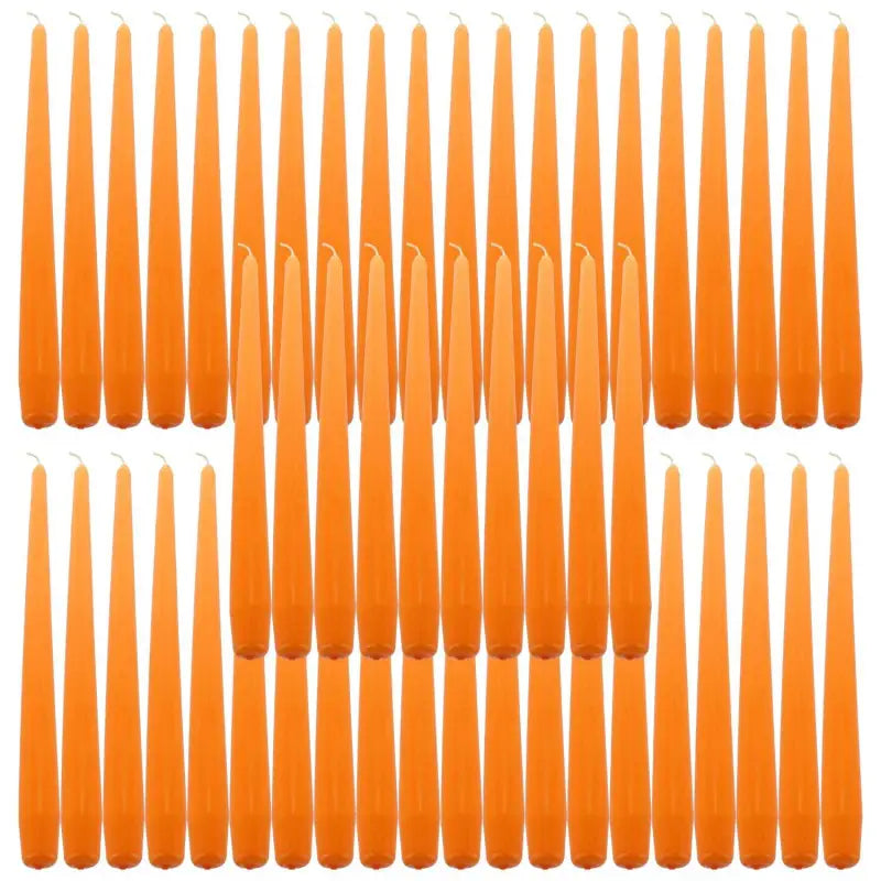 Orange taper dinner candles arranged in rows for elegant dining