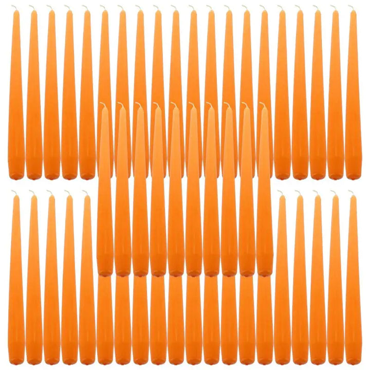 Orange taper dinner candles arranged in rows for elegant dining