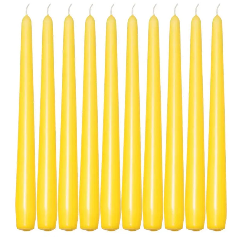 Ten slender yellow taper candles in a row for elegant dinner settings