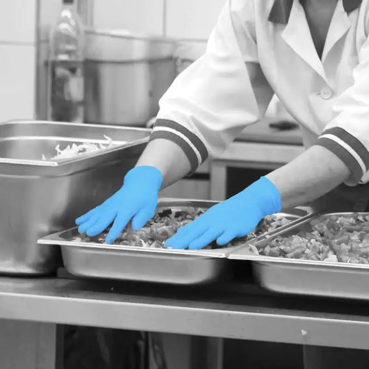 Blue Nitrile Powder Free Disposable Gloves used for handling food in metal trays