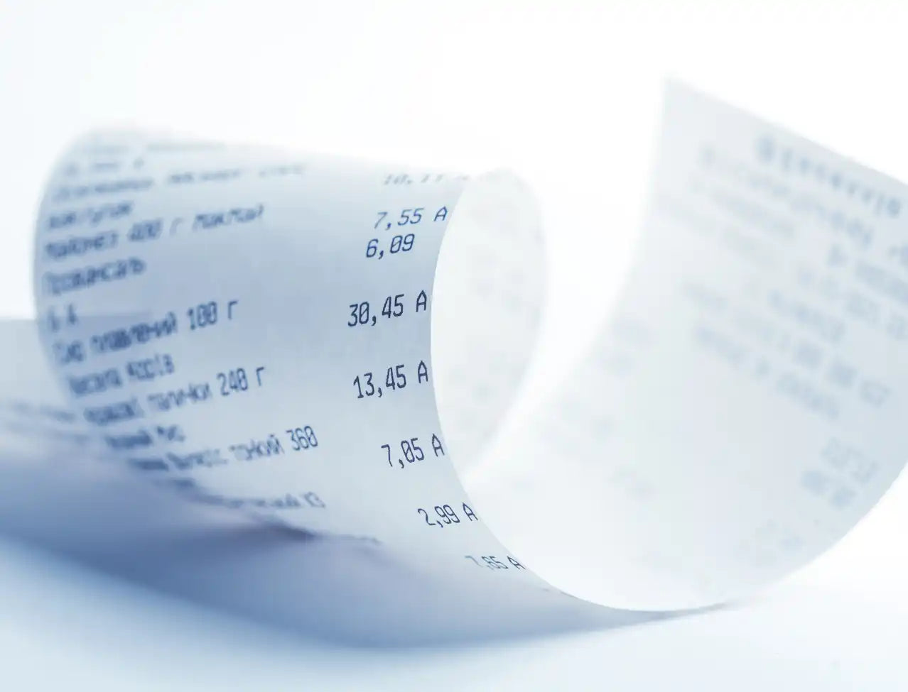 Curled paper receipt with printed numbers and text.