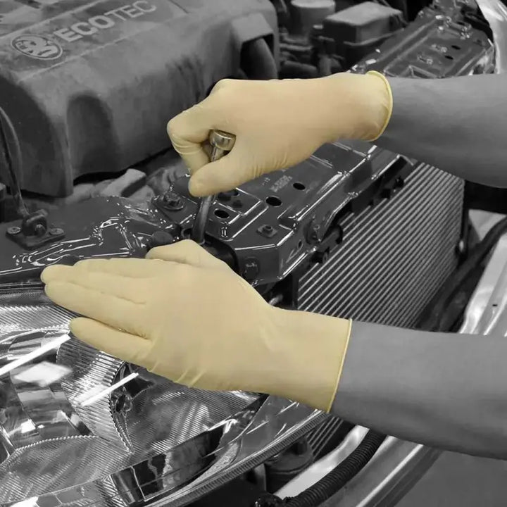 Hands in yellow protective gloves working on a car engine with Natural Latex Powdered Disposable Glove Shield GD45