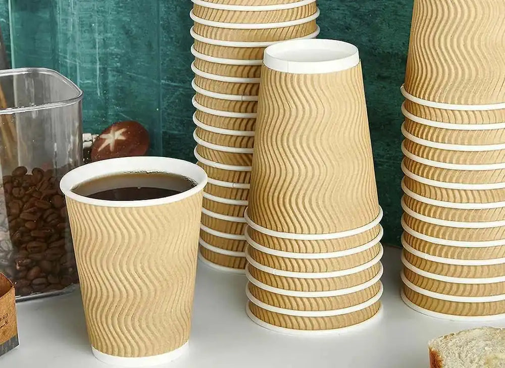 Stacks of disposable paper Ripple coffee cups with wavy textured patterns