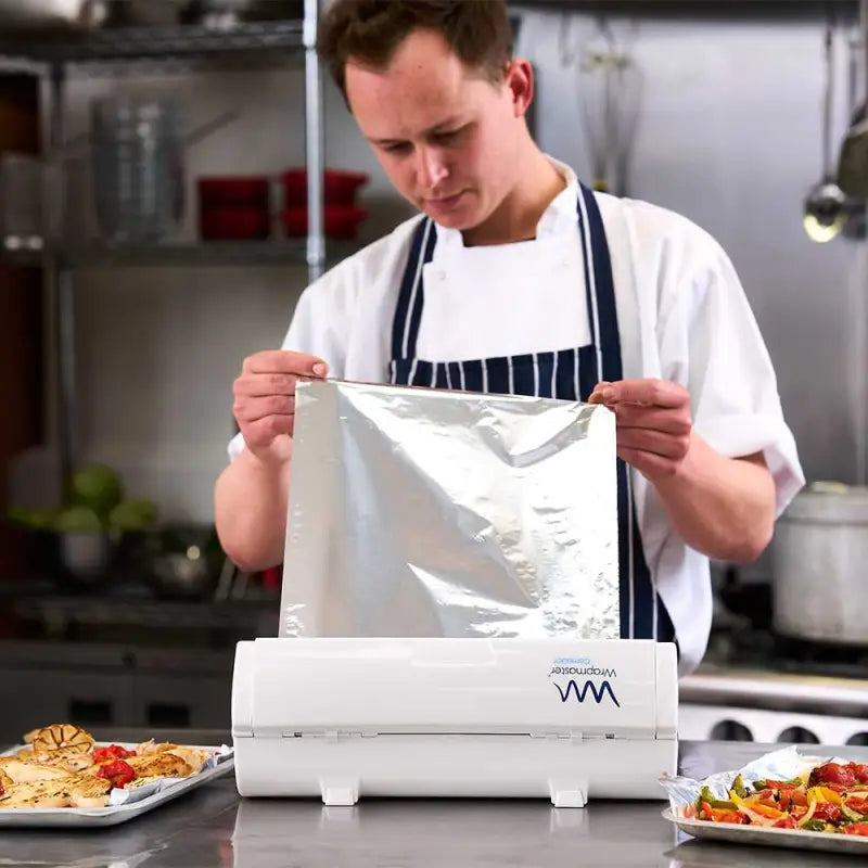 Person using a food vacuum sealer with Wrapmaster 3000 Aluminium Foil 24C54 rolls