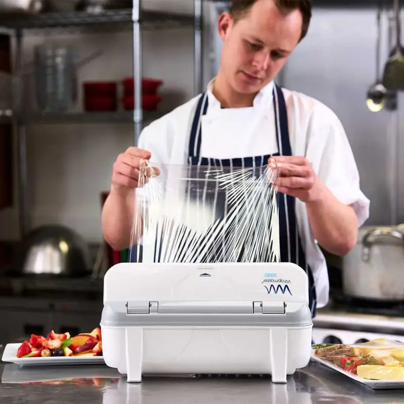 Person using a Food Vacuum Sealer with Wrapmaster 3000 Cling Film 30cm x 300m in kitchen