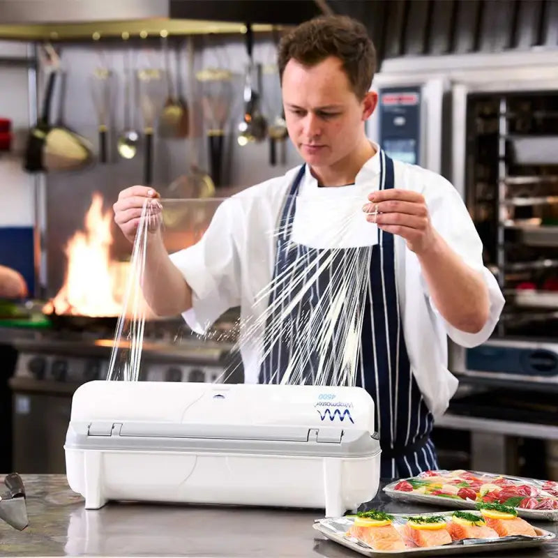 Chef using a food vacuum sealer with Wrapmaster 4500 Cling Film refill 45cm x 300m