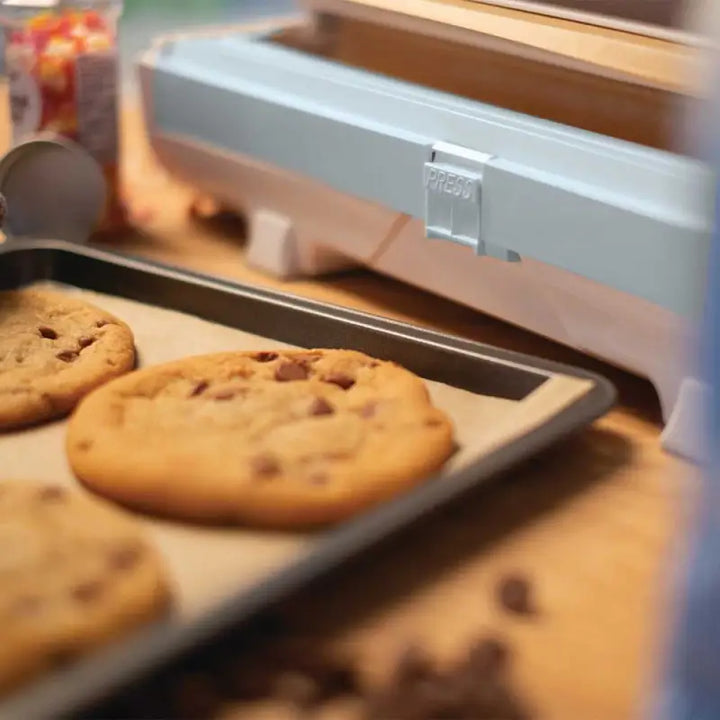 Chocolate chip cookies on a baking sheet with Wrapmaster Compact Baking Parchment