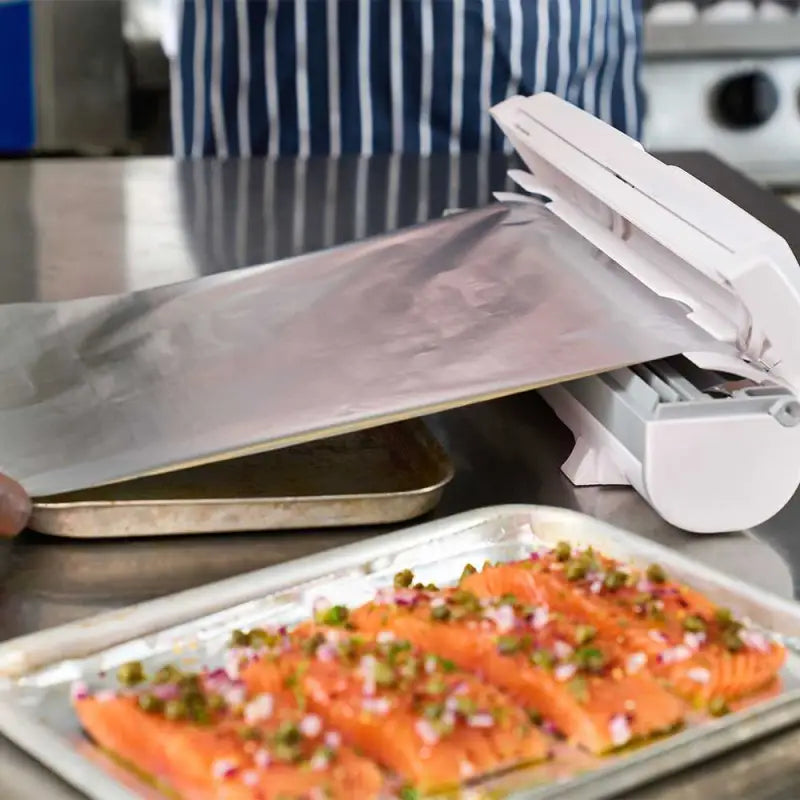 Salmon fillets with herbs on metal tray using Wrapmaster Compact Dispenser 63M15